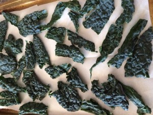 I have found that the kale chips bake the best on a parchment paper lined cookie sheet! 