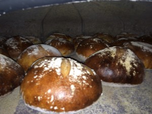 Sneak peek inside the oven!! Almost done! Jonathan taps the loaves to check their progress! 