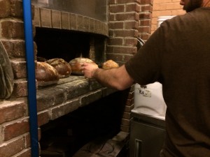 The bread is cooked from the heat retained by the wood-fired oven dishes cooked the previous evening.