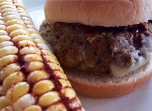 Roasted Corn is always a beautiful compliment to grilled meats. Remove silk from corn. Drizzle with olive oil and sprinkle with paprika, garlic salt, and cayenne pepper. Roast on top shelf of grill for approx 8 mins. Or until a kernel pops with the fork test.